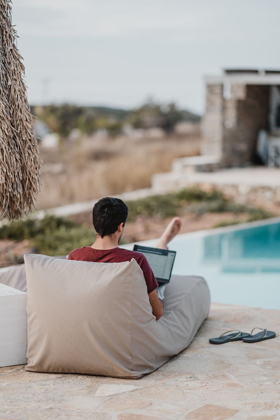 man sitting on lounger while using laptop, back, human, person HD wallpaper