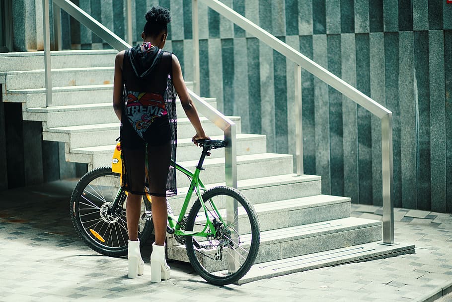 Man in Black Sleeveless Shirt Holding Green Mountain Bike Near Metal Staircase HD wallpaper