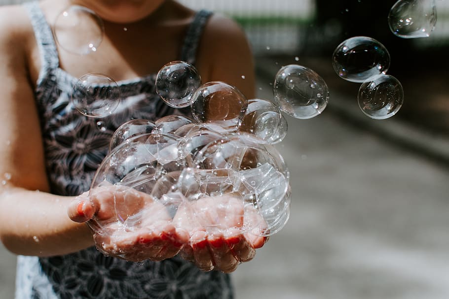 person-holding-soap-bubbles-outdoors.jpg