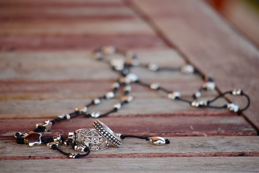 Beaded Black and White Necklace on Brown Wooden Surface, blur HD wallpaper