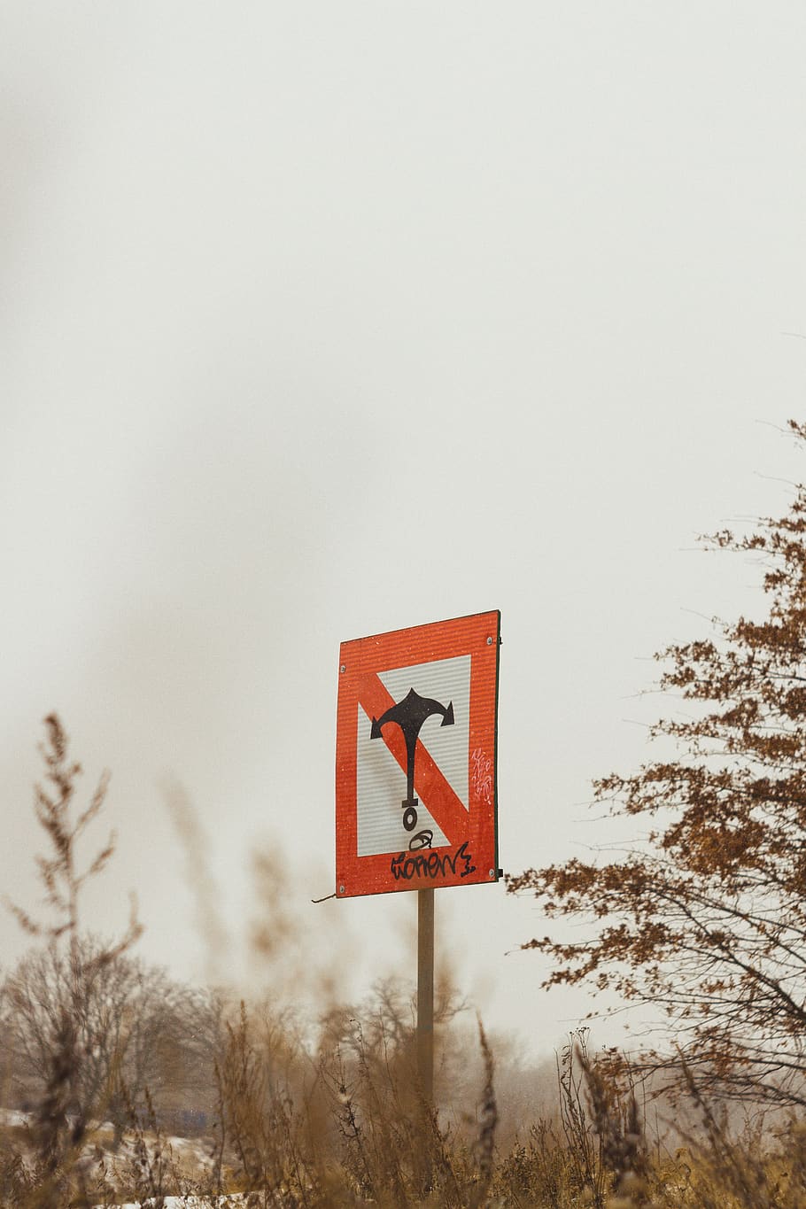 road sign with upright anchor symbol, star symbol, triangle, arrow