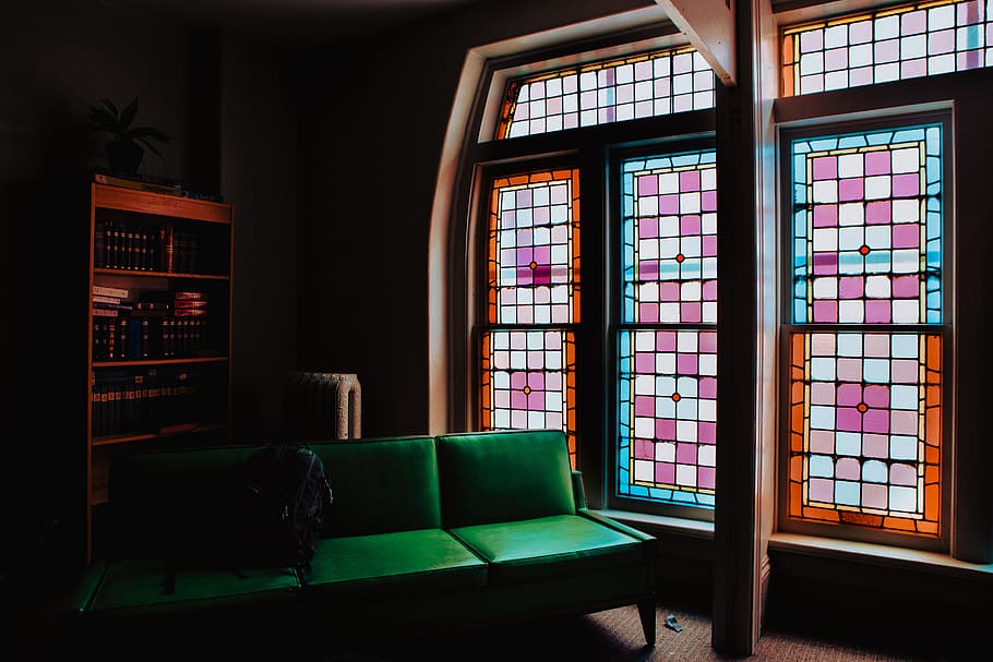 Green Leather Couch Beside of Stained Glass Window, apartment