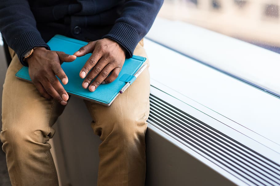 Person Holding Blue Book, electronics, glass window, hands, indoors HD wallpaper