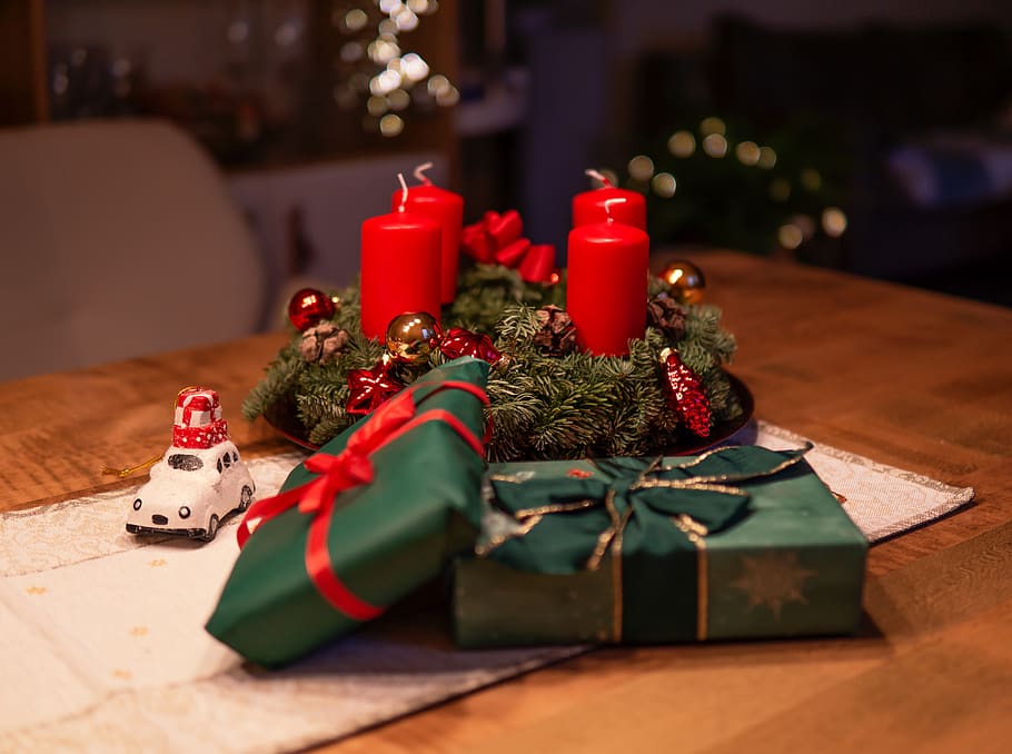 Unlighted Red Advent Candles on Table Beside Green Gift Boxes HD wallpaper