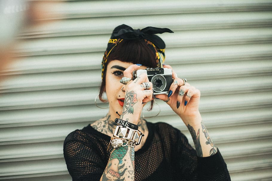 Woman Holding Camera in Front of Roll-up Door, #vietnamese, attractive HD wallpaper
