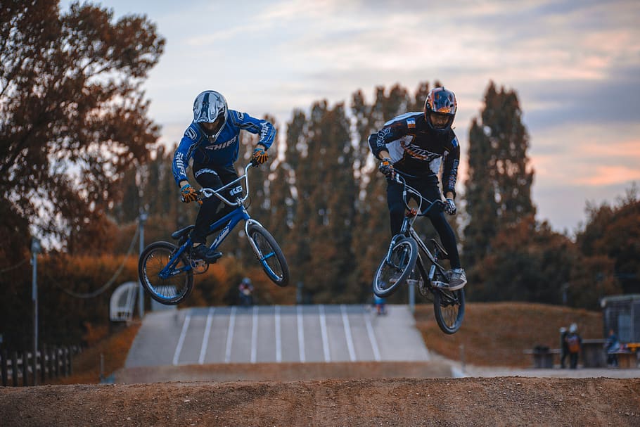 two person doing BMX tricks, sport, sports clothing, competition HD wallpaper