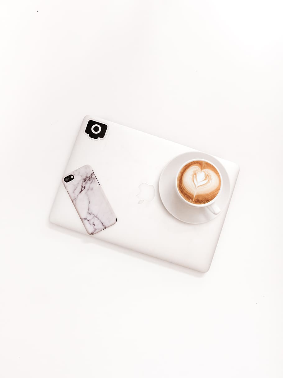 closed silver MacBook on white surface, white background, copy space HD wallpaper
