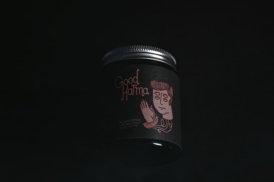 good karma jar with silver lid, black background, finance, indoors