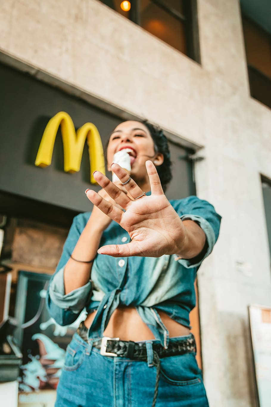 woman eating ice cream near McDonald's, hand, mcdonalds, restaurant