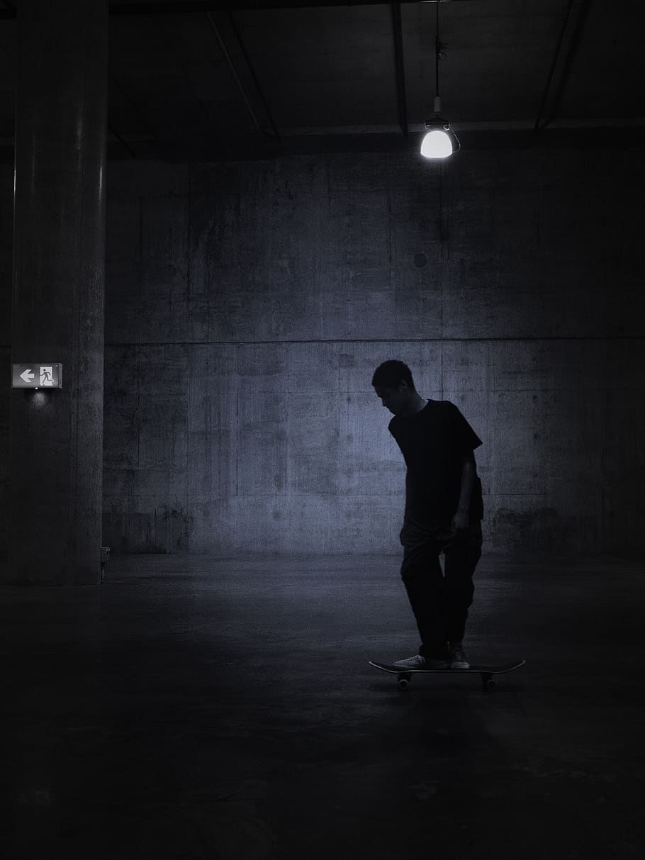 person standing in room, silhouette, lighting, human, skateboard