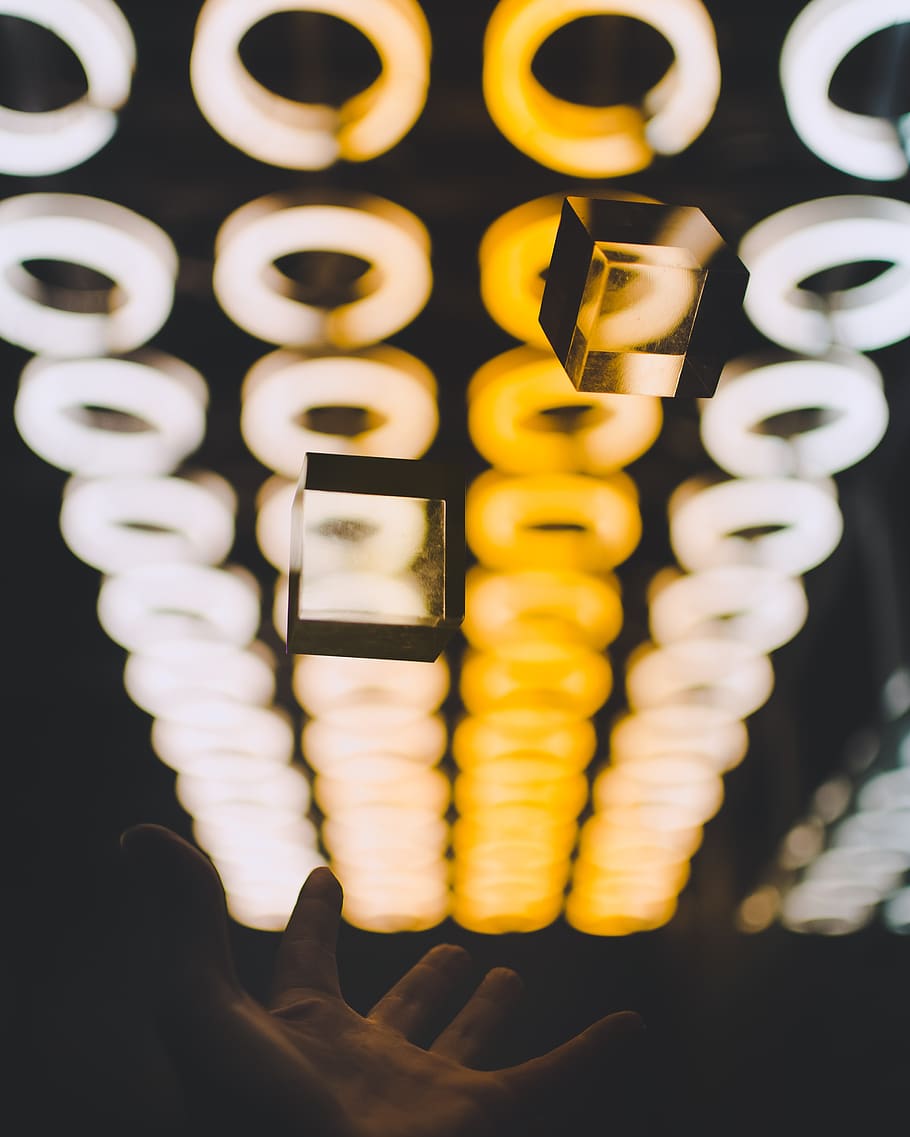 Two Clear Glass Cubes, dark, floating, gold, hand, lights, party HD wallpaper