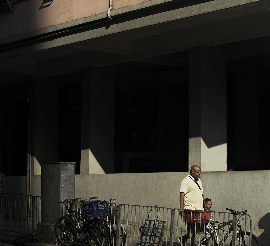 man and boy walking beside building, person, human, vehicle, bicycle HD wallpaper