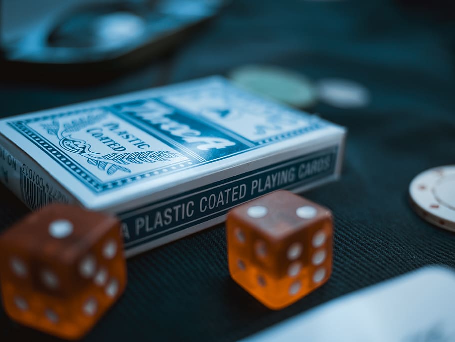 two orange dices beside card deck, selective focus, no people HD wallpaper