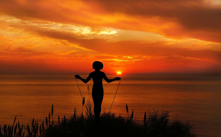 Exercising with jump rope in the sunset., jumping rope, woman
