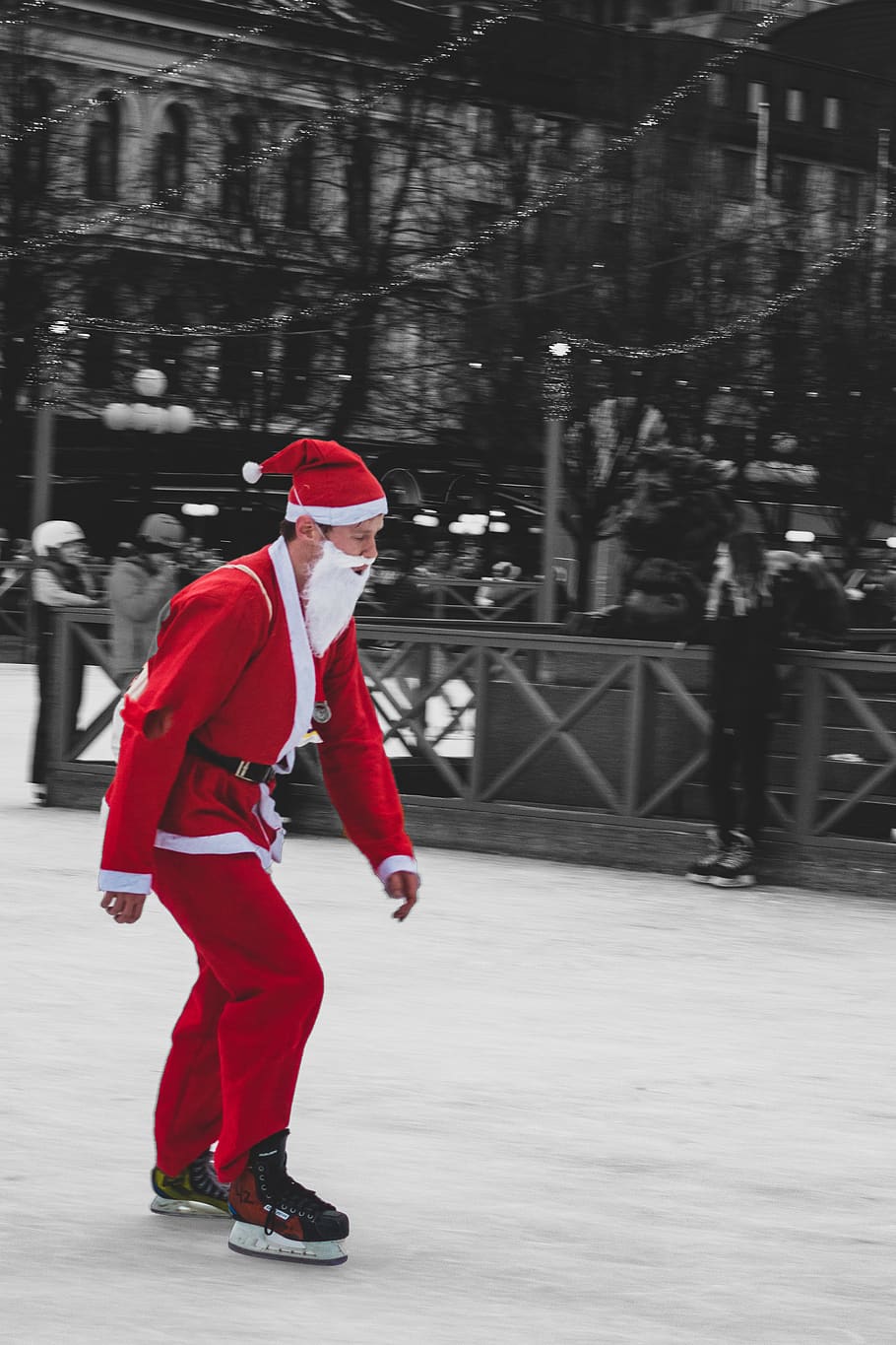 man wearing santa suit while using snow skin boots, skating, human