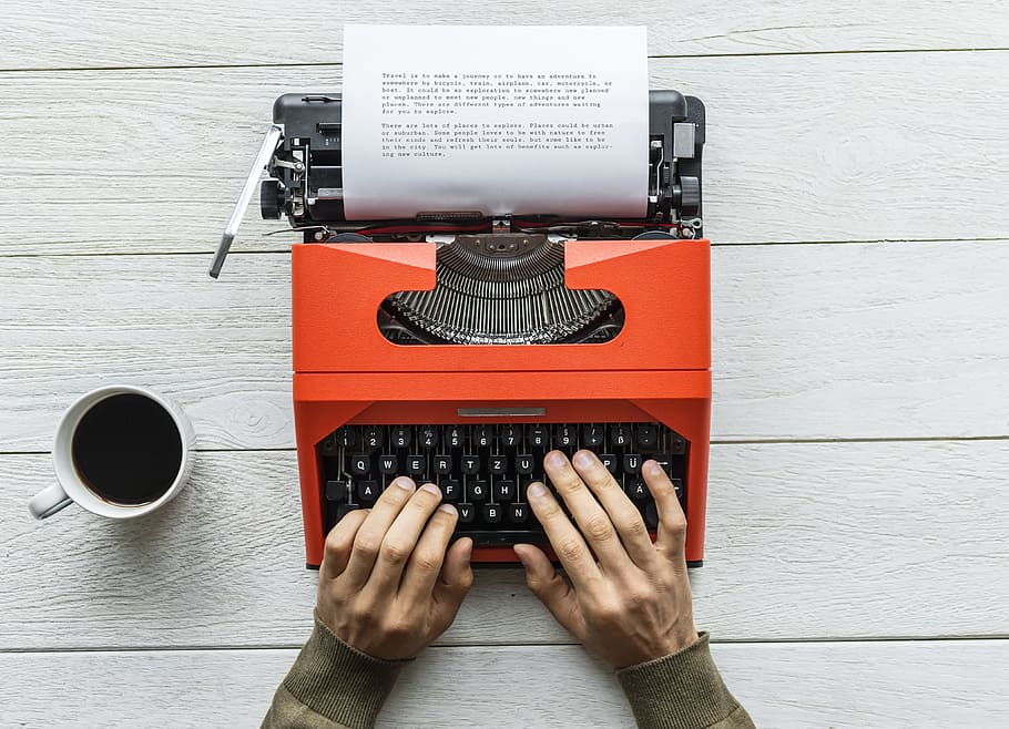Person Holding Black and Orange Typewriter, one person, human hand HD wallpaper