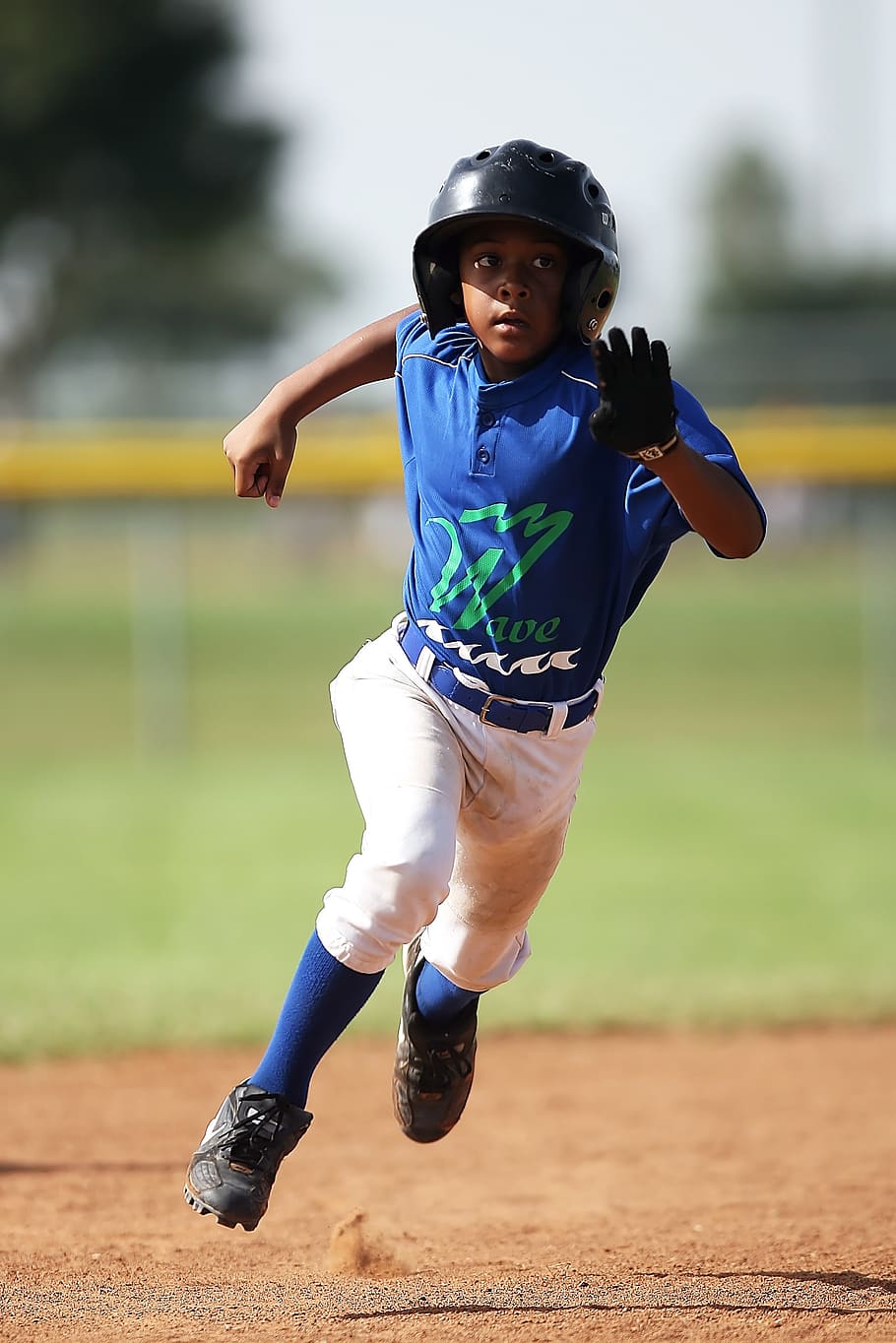 Boy in Blue and White Baseball Jersey Running on Brown Soil Field during Daytime HD wallpaper