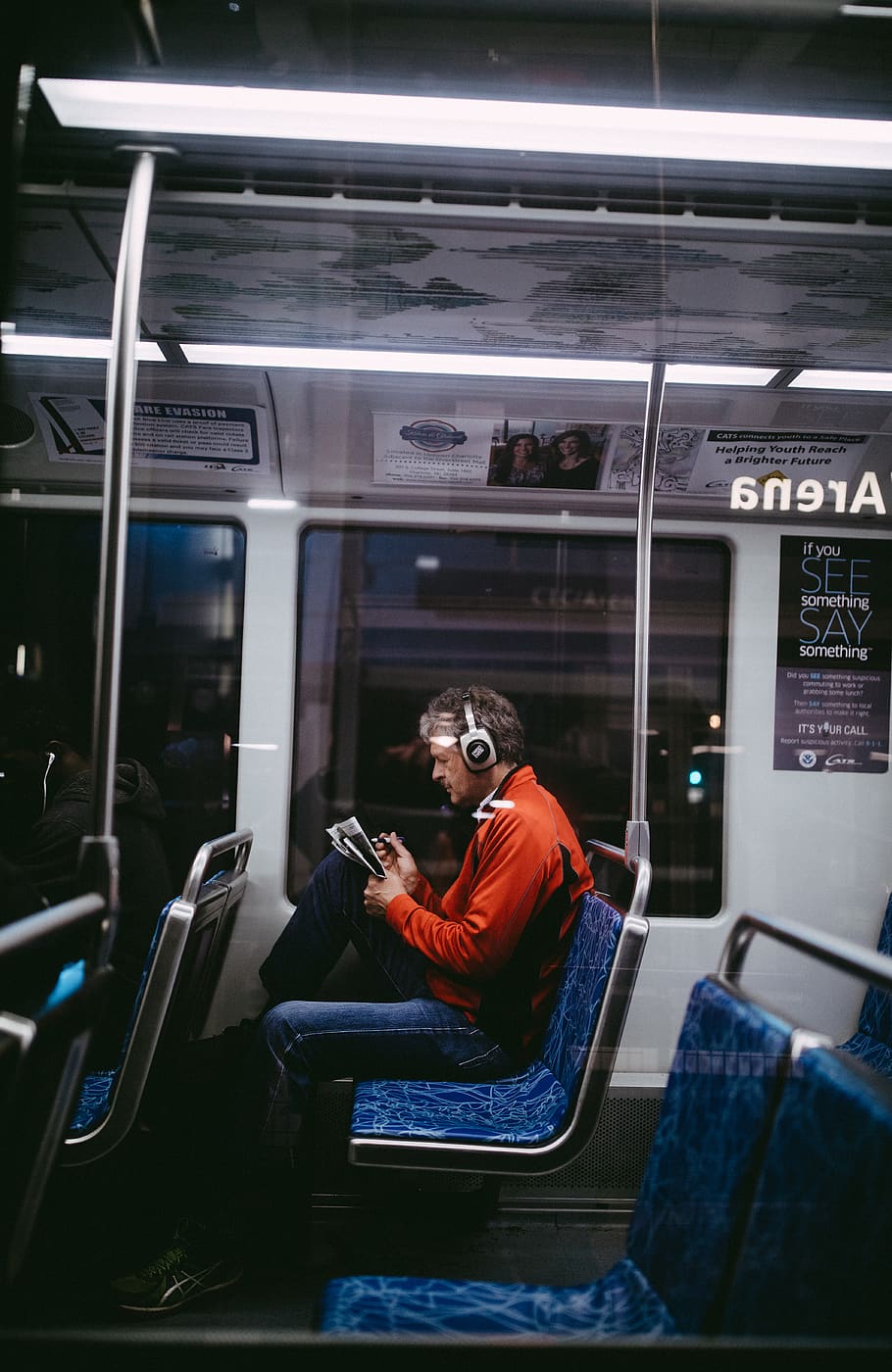 man sitting inside train while reading, one person, real people HD wallpaper