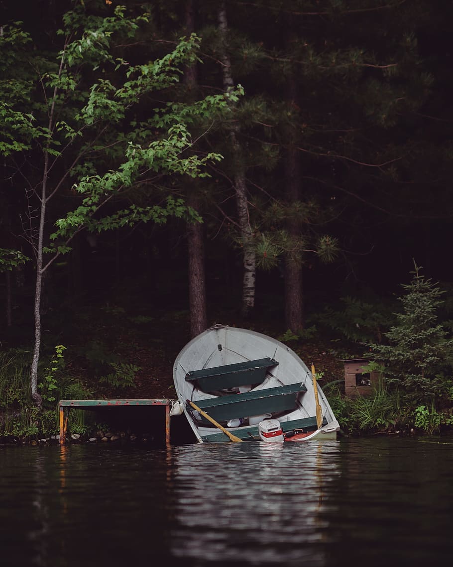 canoe on dock, abandoned, capsized, sunk, broken, crashed, wreck
