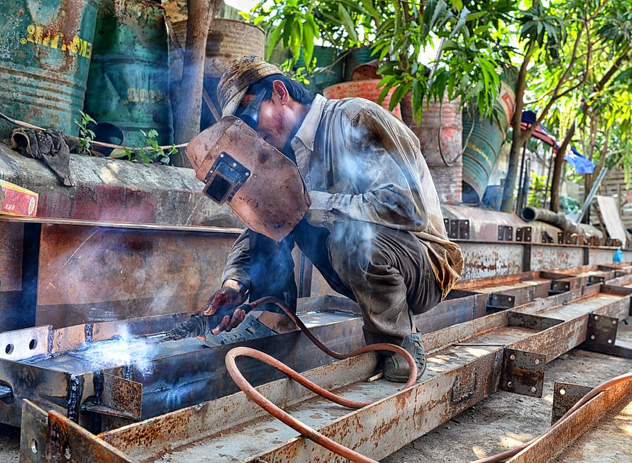 man using welding machine, one person, mammal, domestic, domestic animals HD wallpaper