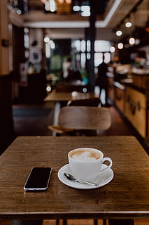 Cup of coffee on table in cafe, interior, tech, technology, work HD wallpaper