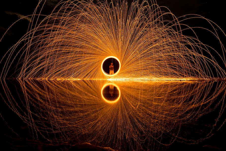person holding circular light, steel wool, long exposure, spin