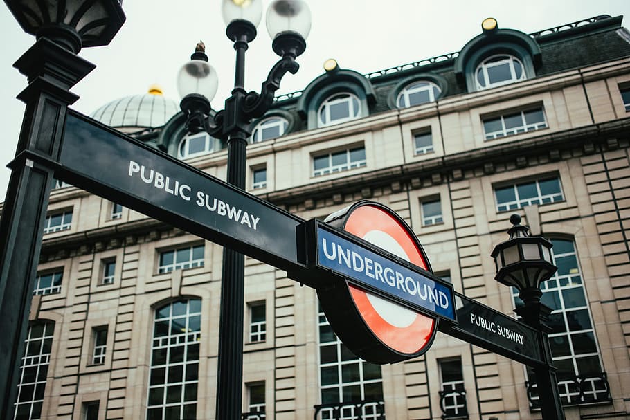 Perspective view of London public subway underground signboard with a building in the background