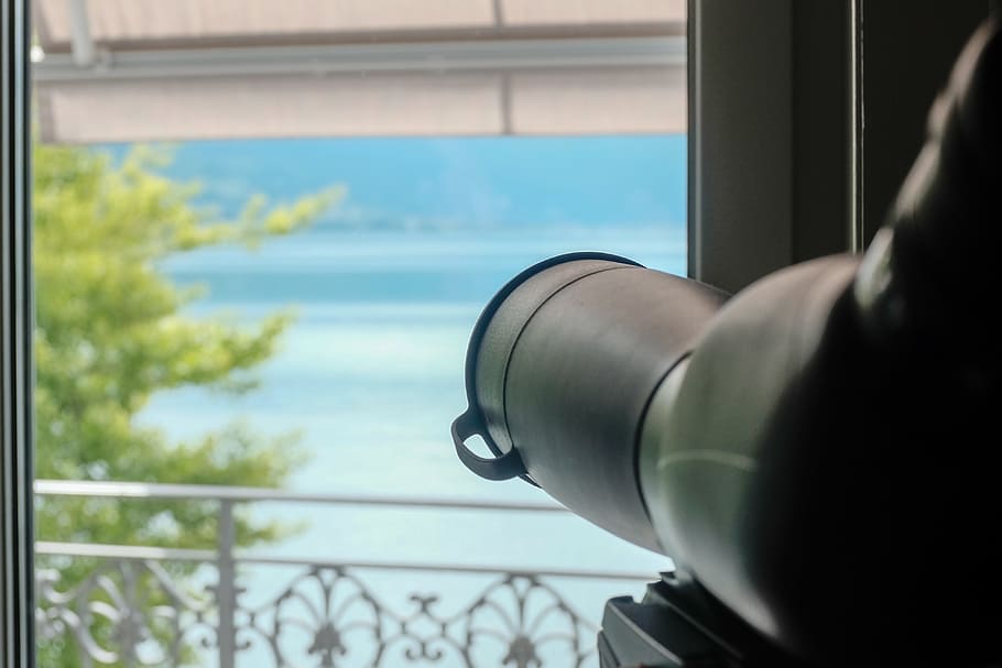 Telescope aimed in window, aiming, background, city, closeup