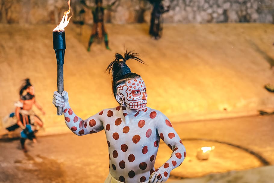 man holding torch with fire, focus on foreground, human arm, traditional clothing HD wallpaper