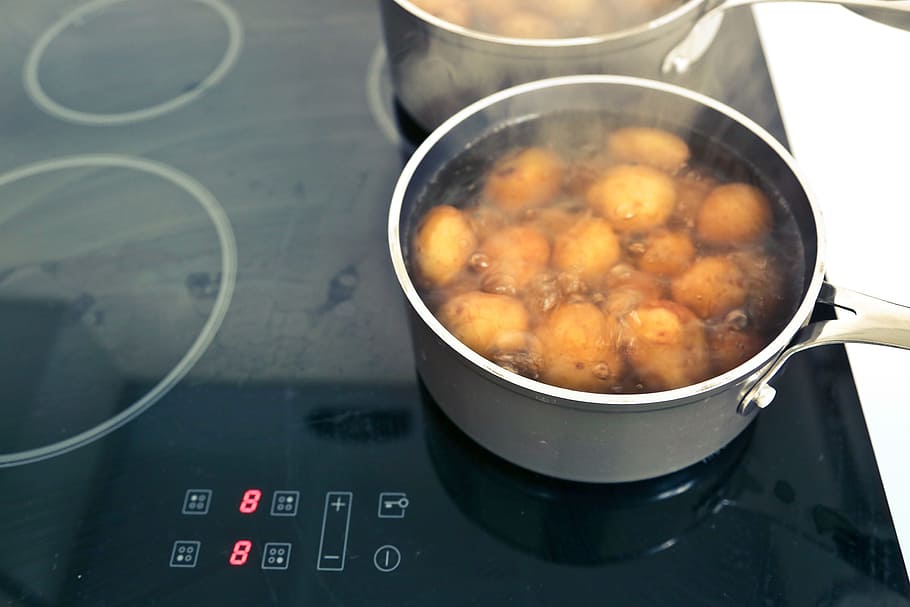 Potatoes boiling in the pots on multi zone induction hob, black HD wallpaper