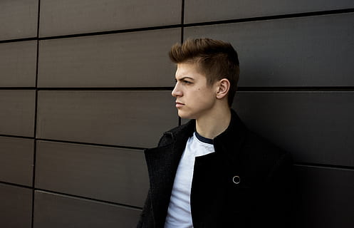 man leaning on gray wall, apparel, clothing, person, human, coat HD wallpaper