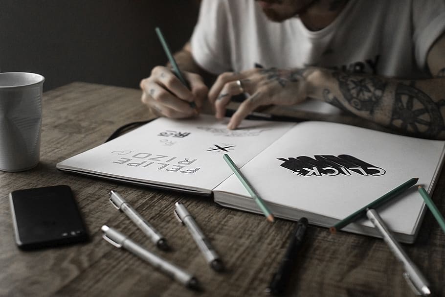 person writing on book, indoors, table, creativity, art and craft HD wallpaper