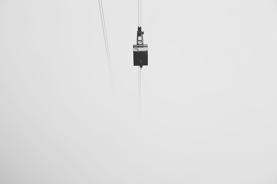 low-angle photography of cable car under gray skies, gondola