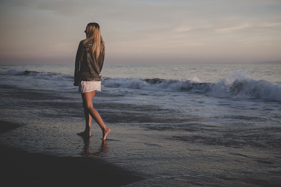 woman walking on seashore under gray sky, evening, coast, sand HD wallpaper