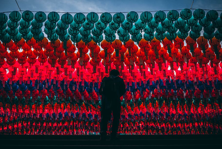 man standing under lanterns, human, person, crowd, rug, building HD wallpaper