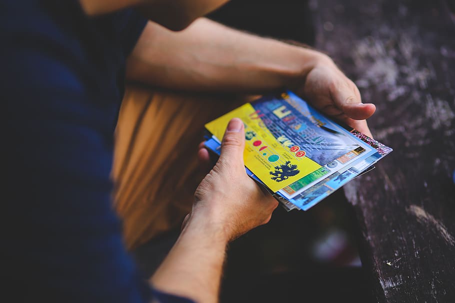 Man looking at postcards, mail, ticket, human hand, one person HD wallpaper