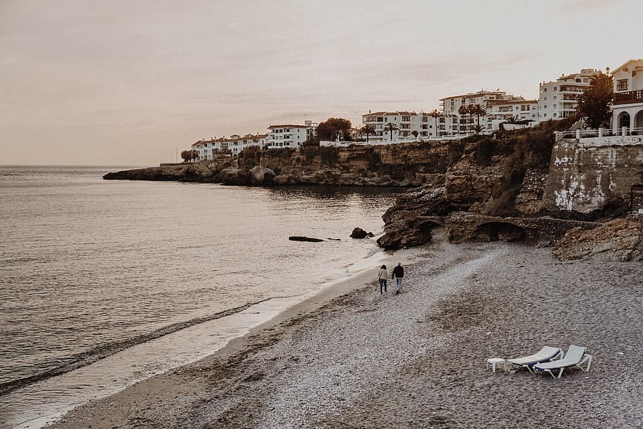 Two Person Walking on Seashore, architecture, beach, cliff, coast HD wallpaper