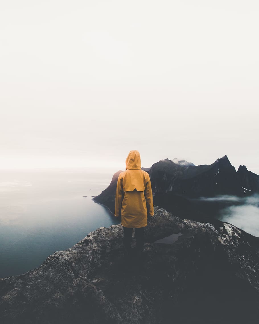 person standing on cliff, rock, mountain, lake, top, jacket, rain jacket, HD wallpaper