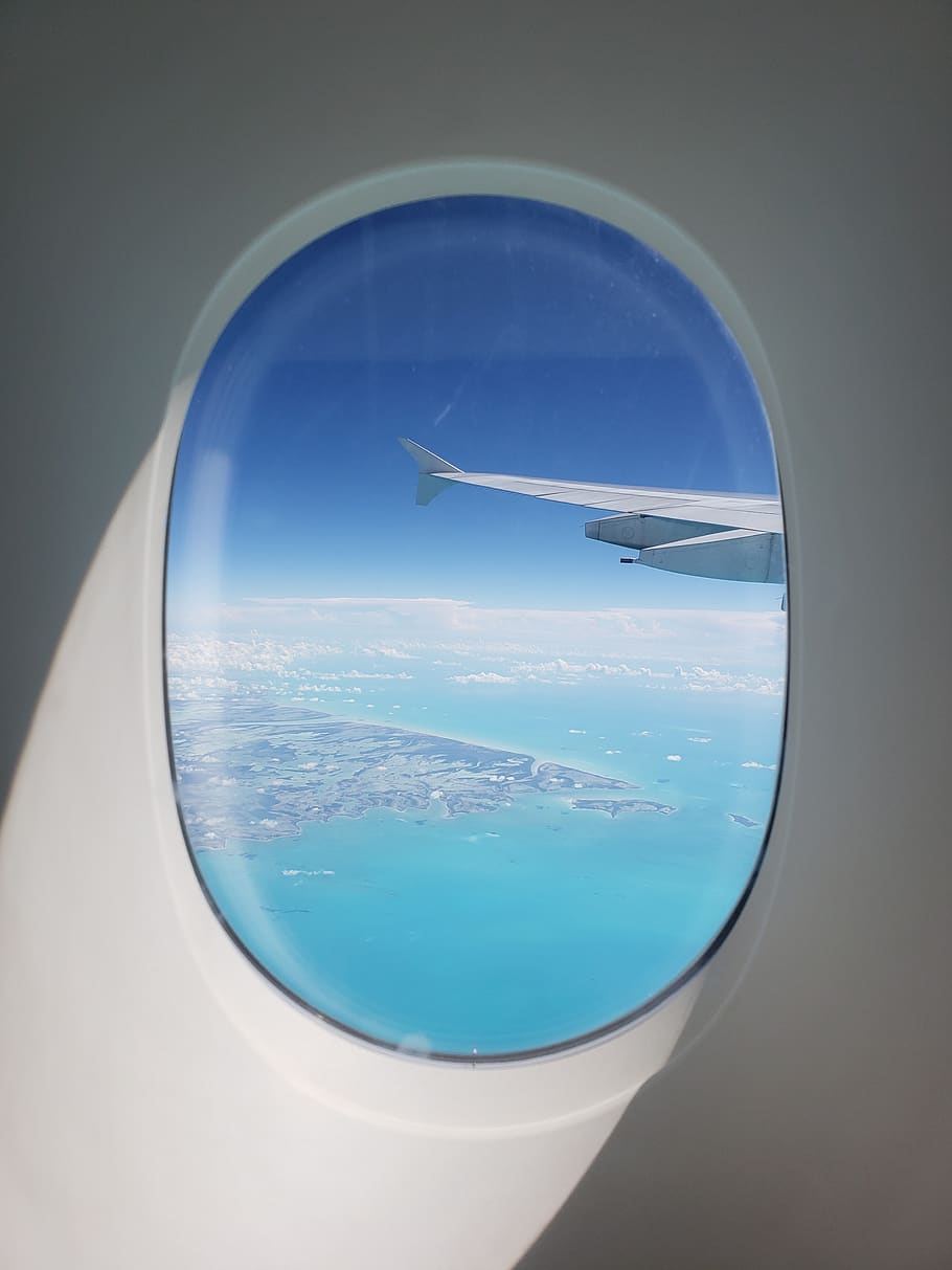 plane wing on air above body of water during daytime, porthole, HD wallpaper