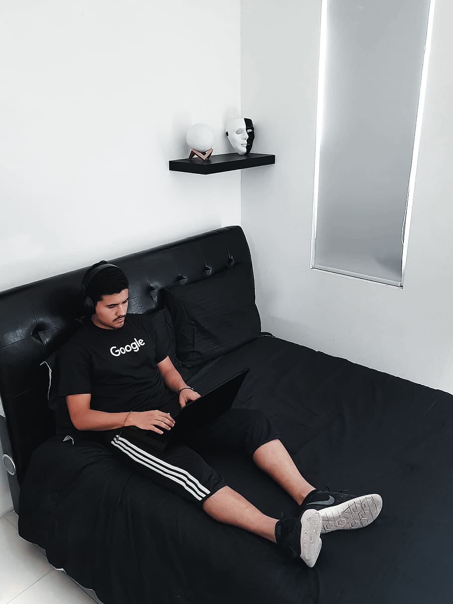 man sitting on bed using laptop computer, one person, real people HD wallpaper