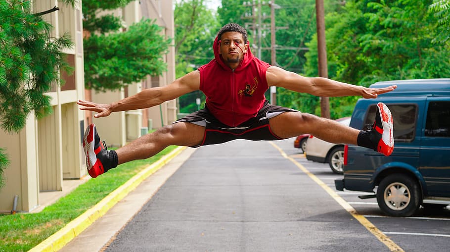 Man Jumping at the Pathway Beside Parking Lot, active, cars, daylight HD wallpaper