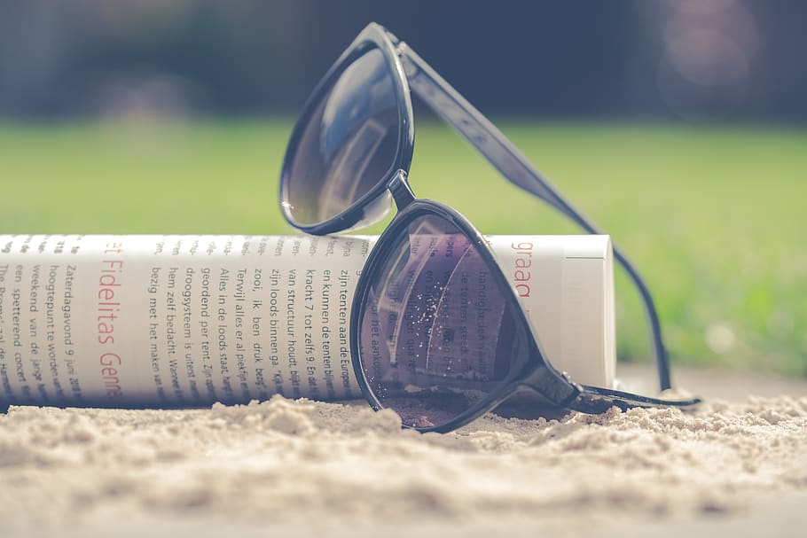 Black Sunglasses on Book, plastic, sand, text, land, selective focus HD wallpaper