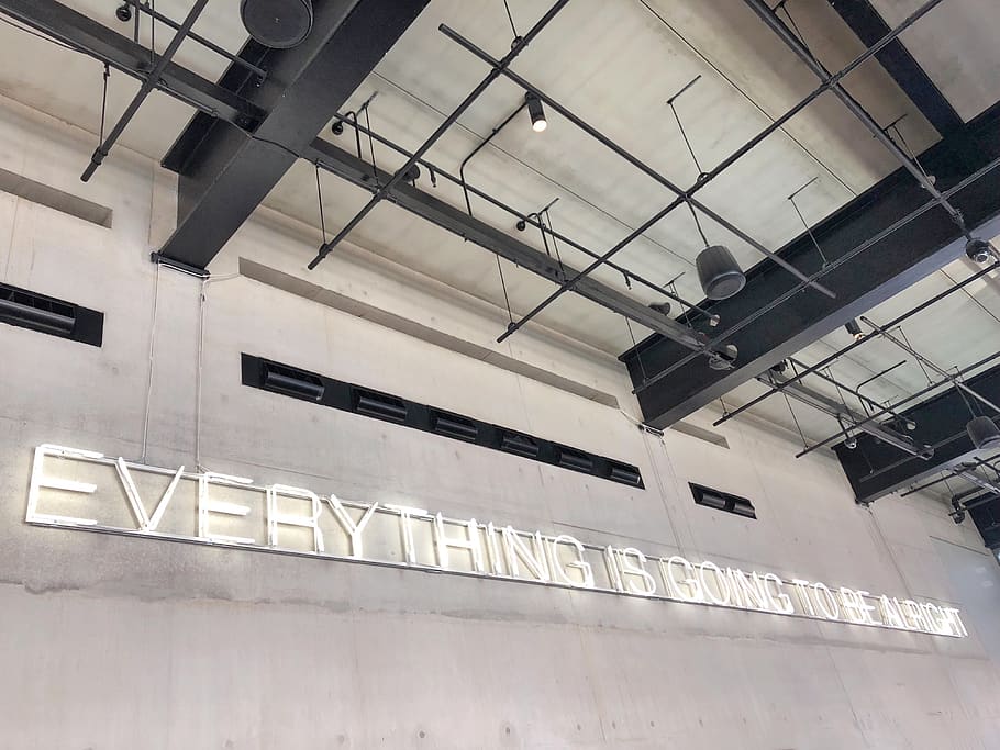 everything is coming to be alright wall text, building, hangar