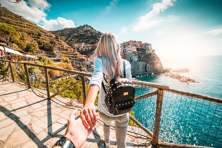 Look From Behind At Young Woman Holding Mans Hand In Follow Me Pose Young  Cute Female Traveler With Backpack Stock Photo - Download Image Now - iStock