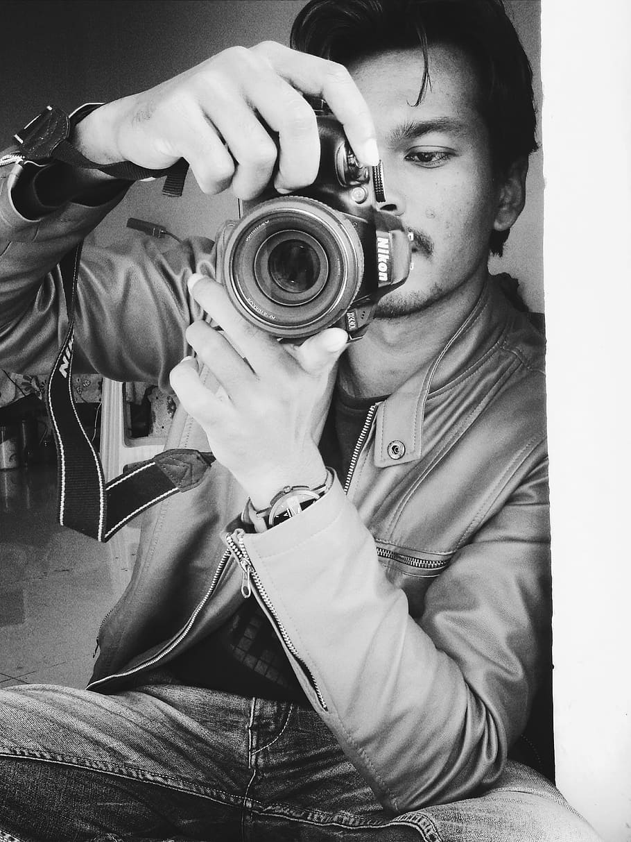 Monochrome Photography of Man Holding Black Nikon Camera, adult