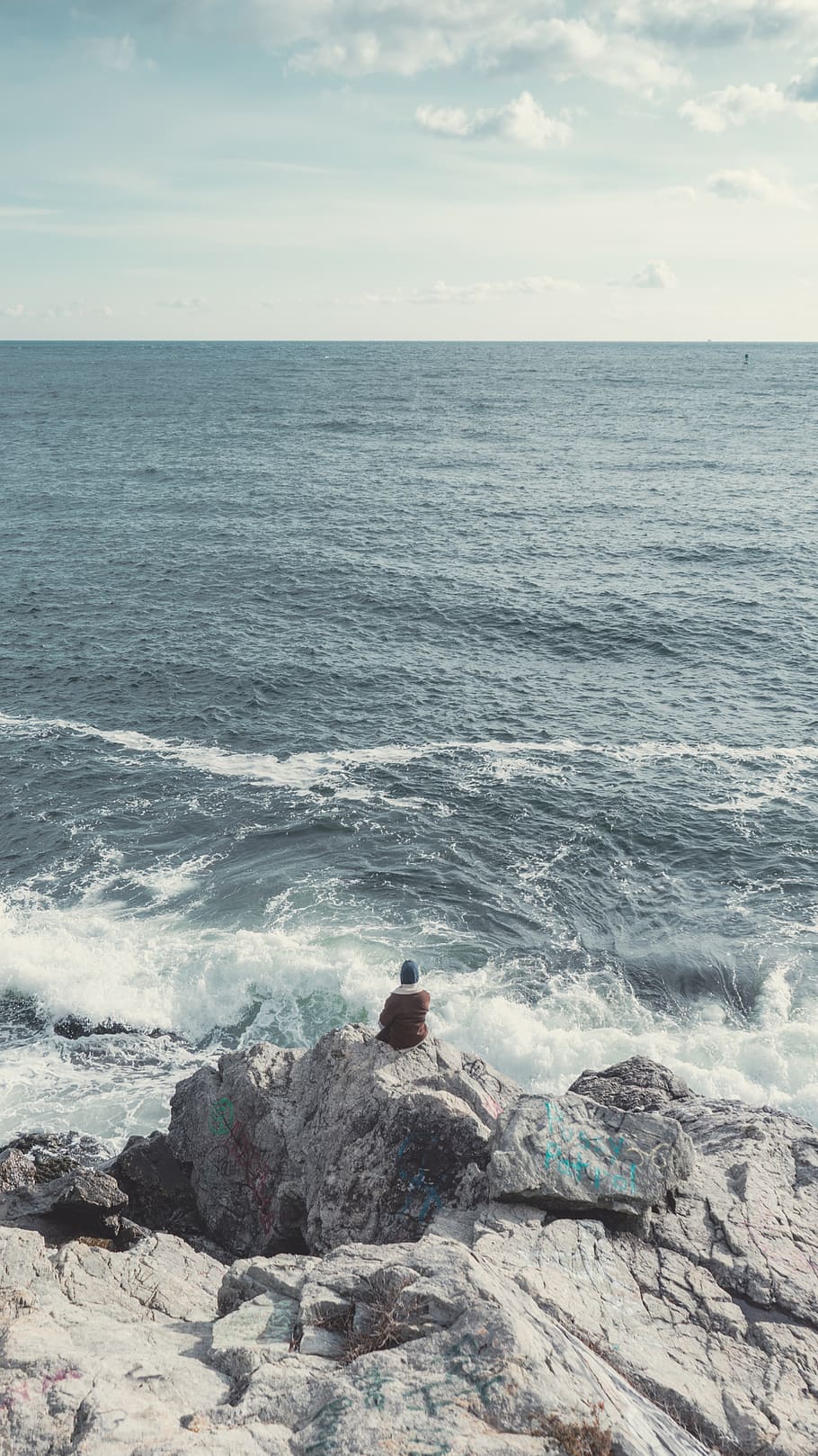 Person Sitting on Gray Rock Near Sea, adventure, beach, beauty HD wallpaper