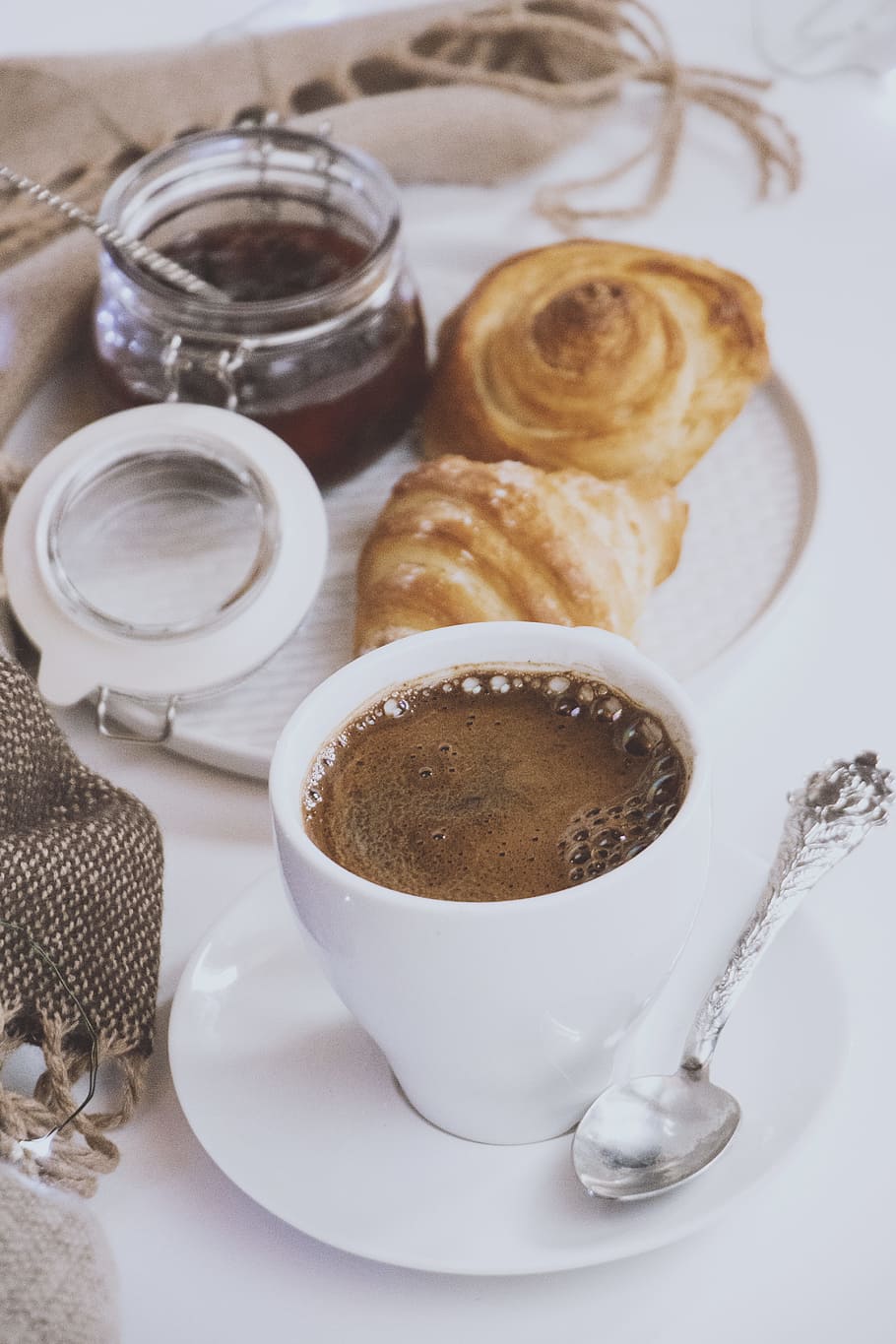 white ceramic mug filled with brown liquid on saucer near bread HD wallpaper