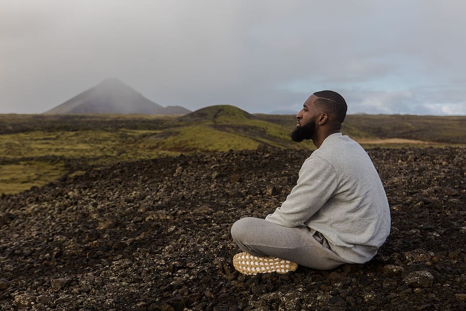 Man in White Top Sitting on Brown Soil, adventure, arid, clouds HD wallpaper