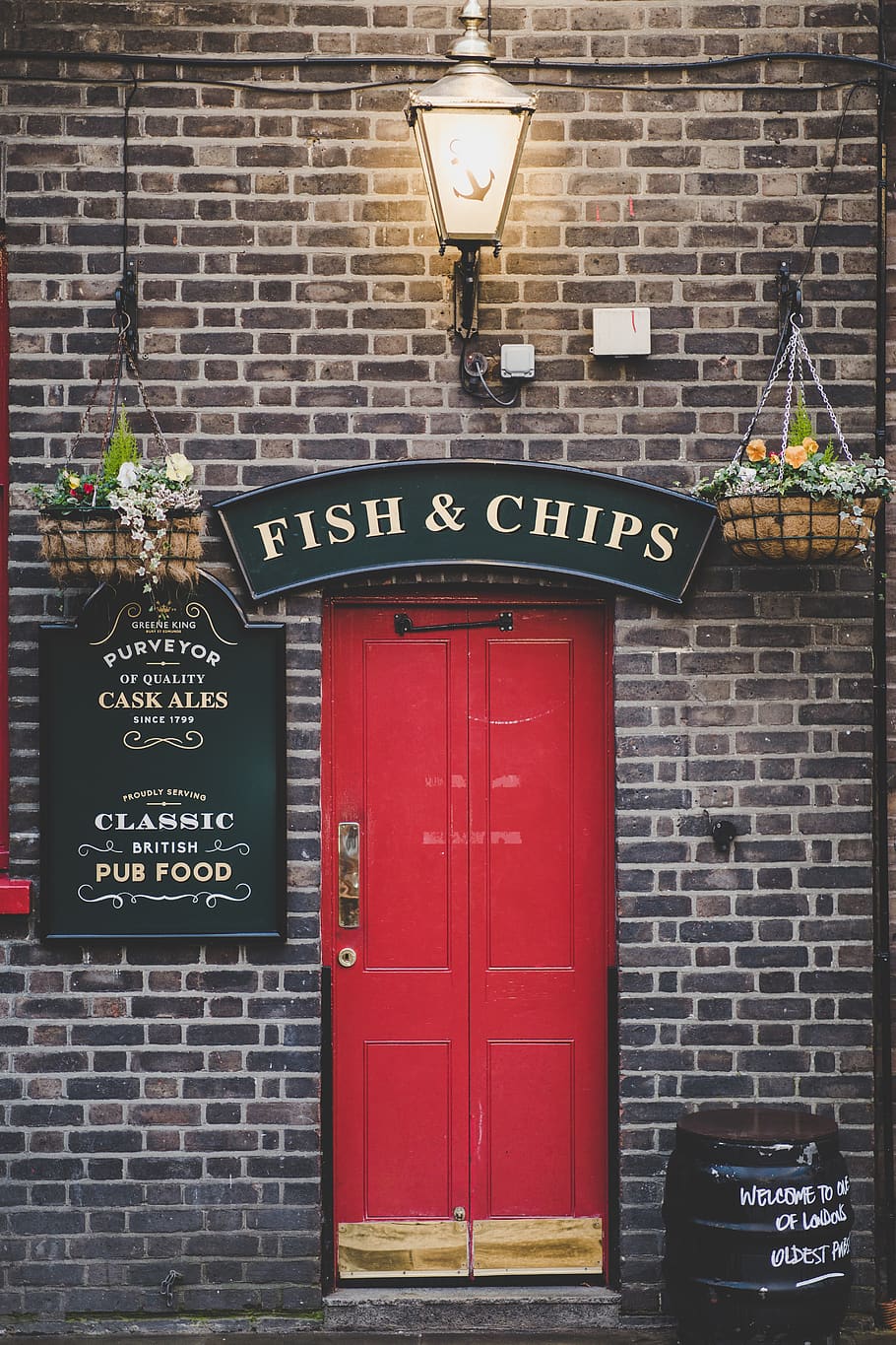 Fish & Chips signage over red door, brick, london, united kingdom