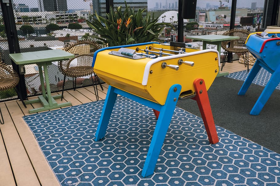 yellow, red, and blue foosball table, furniture, chair, rug, plywood